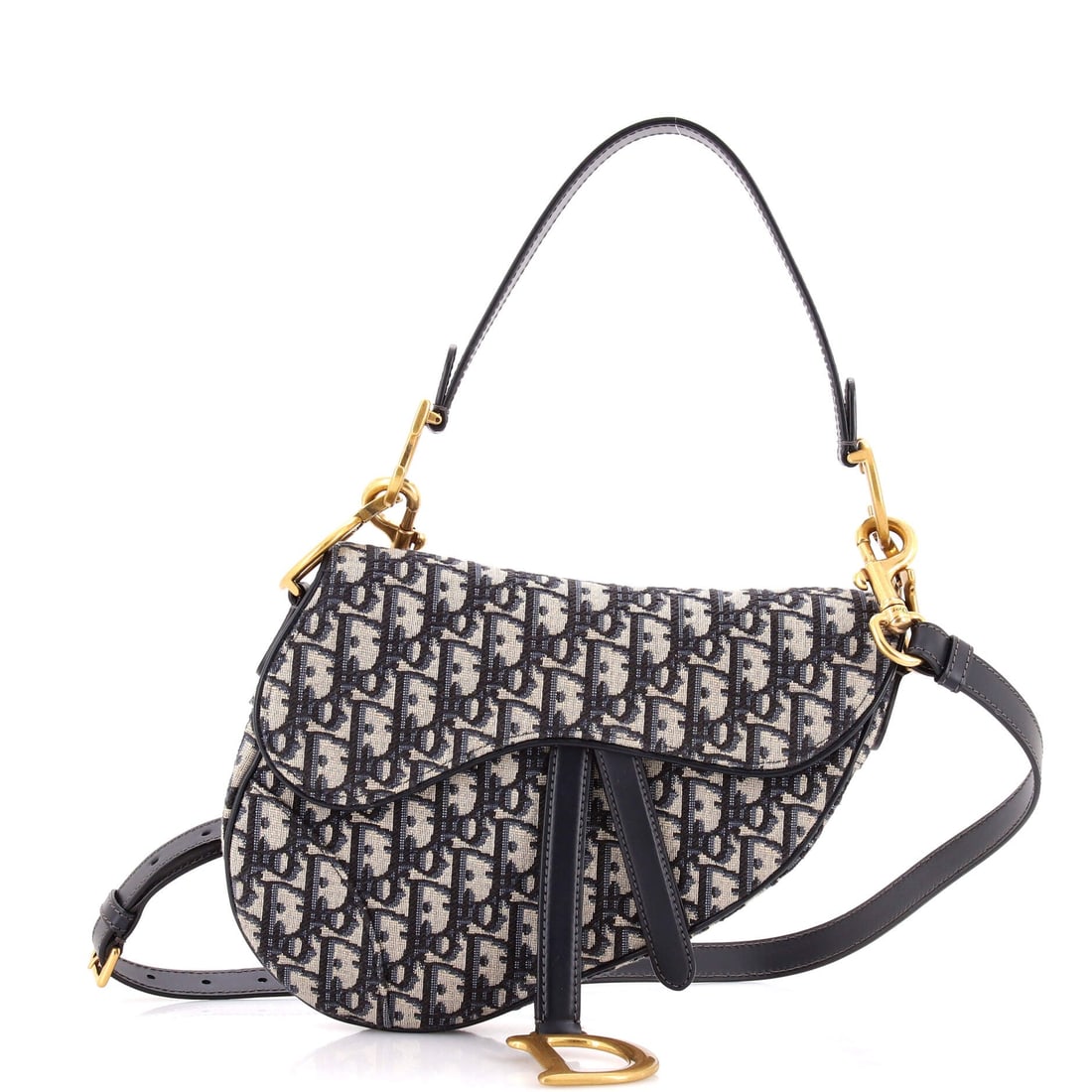 Christian Dior Saddle Handbag with Strap Oblique Canvas Medium: The Christian Dior Saddle Handbag with Strap reads as the maison's quiet refinement of an already mature silhouette, with the small adjustments the house has banked over the years. The body reads in O