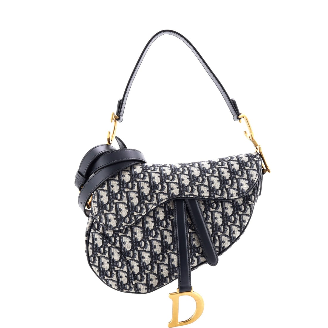 Christian Dior Saddle Handbag with Strap Oblique Canvas Medium: Opened up, the Christian Dior Saddle Handbag with Strap reveals an interior tuned for daily use rather than for display, with the house's familiar attention to pocket placement. Built in Oblique canva