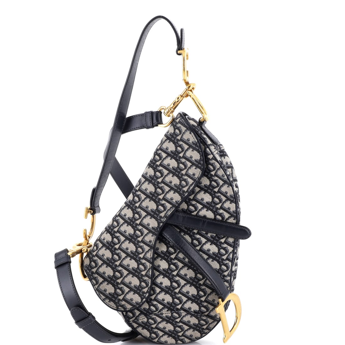 Christian Dior Saddle Handbag with Strap Oblique Canvas Medium: The Christian Dior Saddle Handbag with Strap carries with the assured ergonomics the maison has refined over multiple iterations, comfortable on the shoulder and natural in the hand. The body reads in