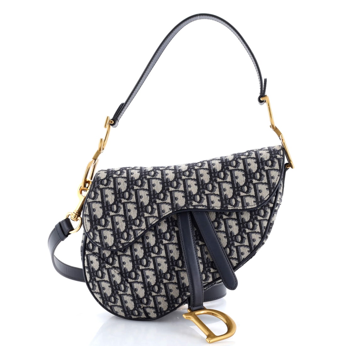 Christian Dior Saddle Handbag with Strap Oblique Canvas Medium: The Christian Dior Saddle Handbag with Strap opens into the kind of interior the house designs for real life, with the layout calibrated to what actually moves in and out of a bag through a day. The b