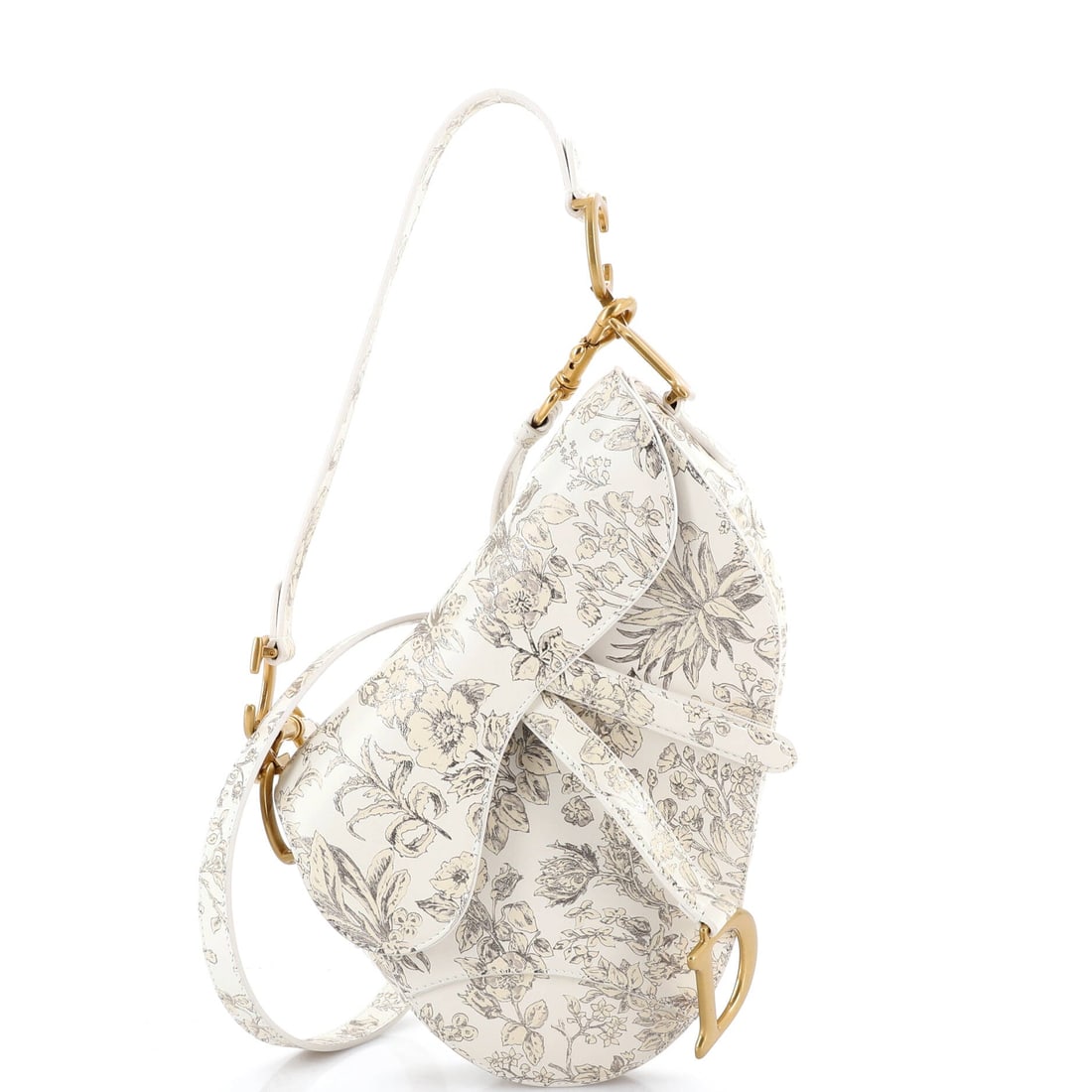 Christian Dior Saddle Handbag with Strap Printed Leather Medium: Run a finger across the Christian Dior Saddle Handbag with Strap and the leather - printed calfskin treated with the house's editorial print - reads as the kind of hide the house puts behind its bette