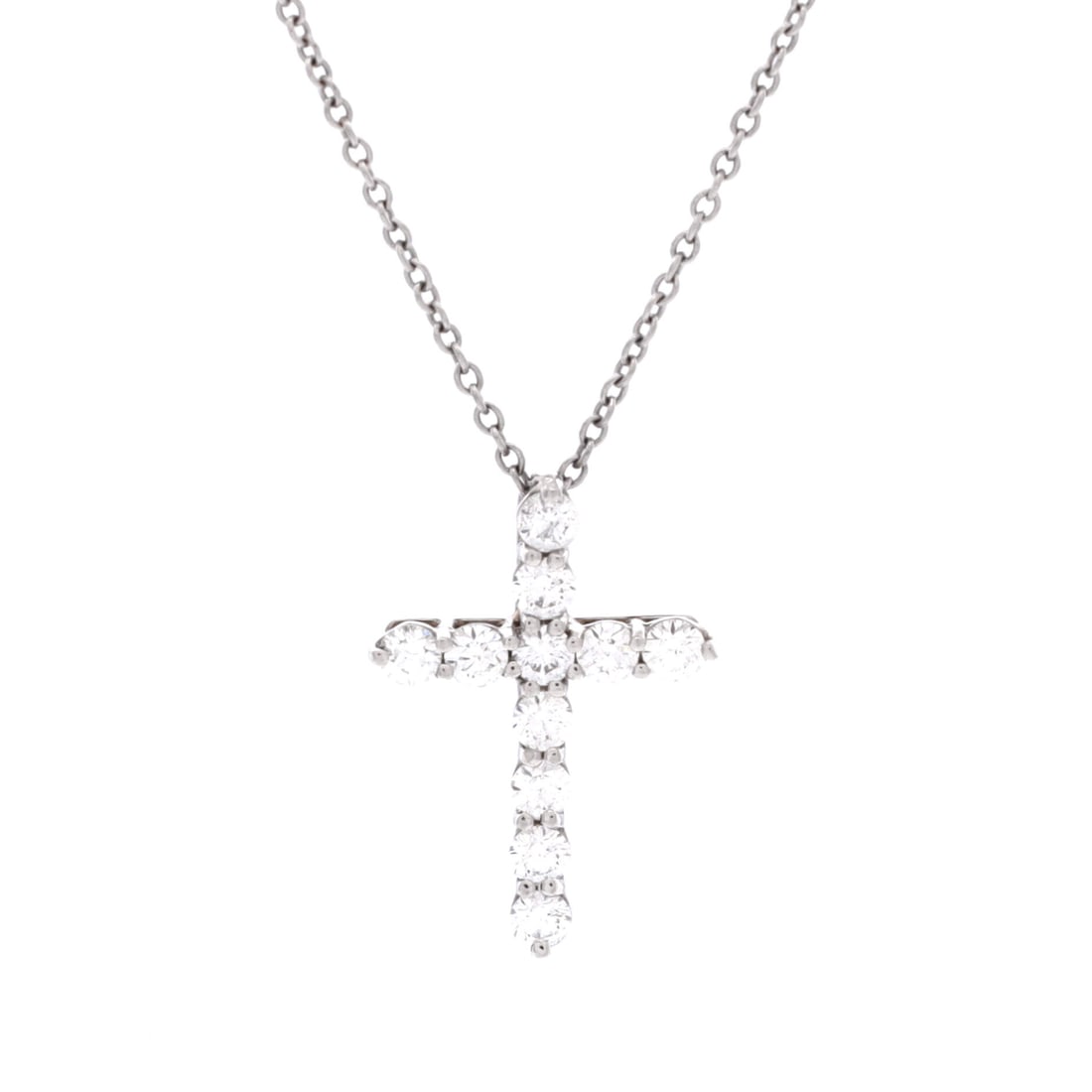 Tiffany & Co. Cross Pendant Necklace Platinum and Diamonds Small Silver: The Tiffany & Co. Cross Pendant Necklace in Platinum, set with diamonds. The diamonds add a measure of brightness and lift the piece's presence on the wrist or neckline. The piece offers clear designe
