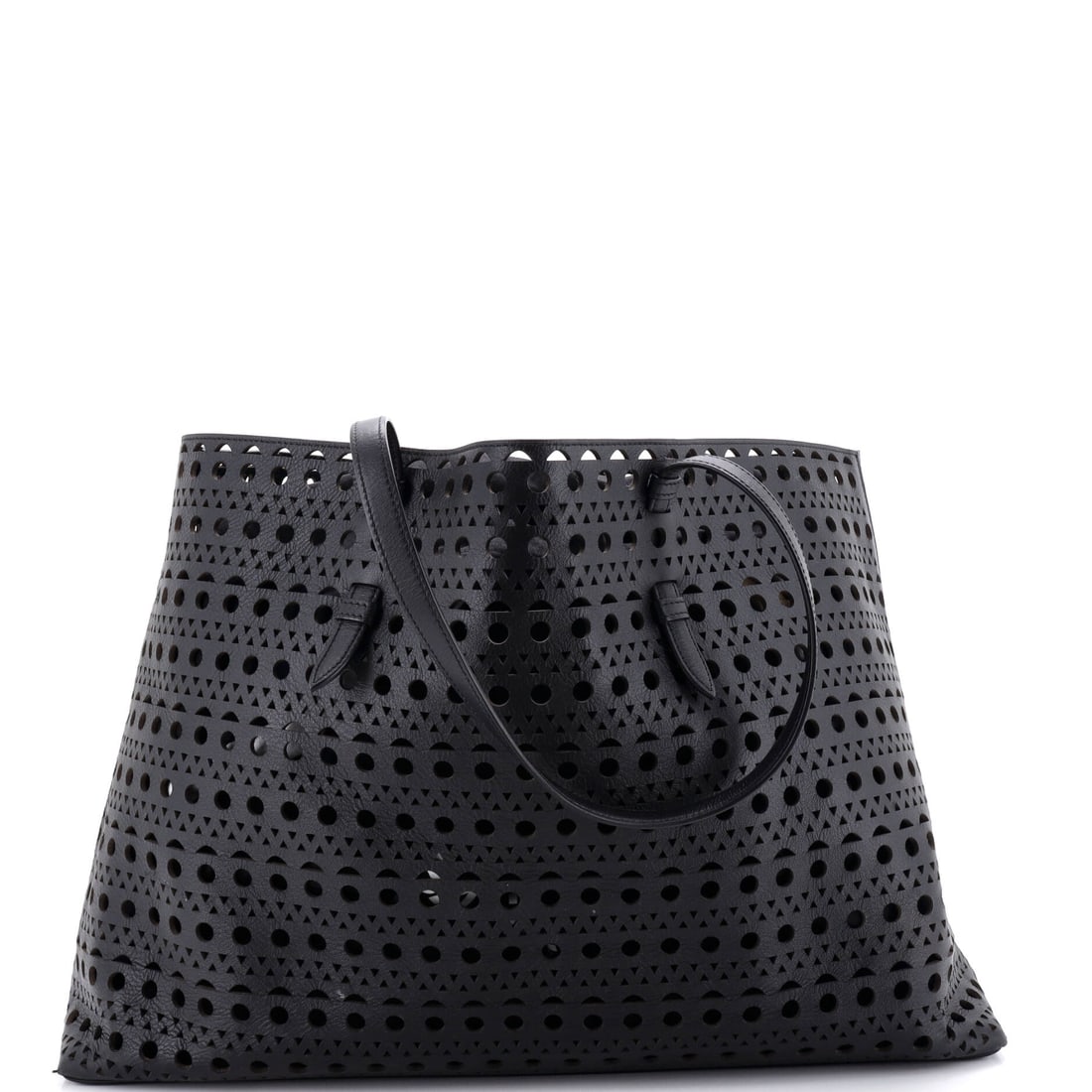 Alaia Mina Tote Laser Cut Leather 44 Black: The Alaia Mina Tote Laser Cut in black leather. Catalogued in the 44 size. Maison de Beaubigonne stands behind the authenticity of this piece. The silhouette reads clearly across the room, giving it s