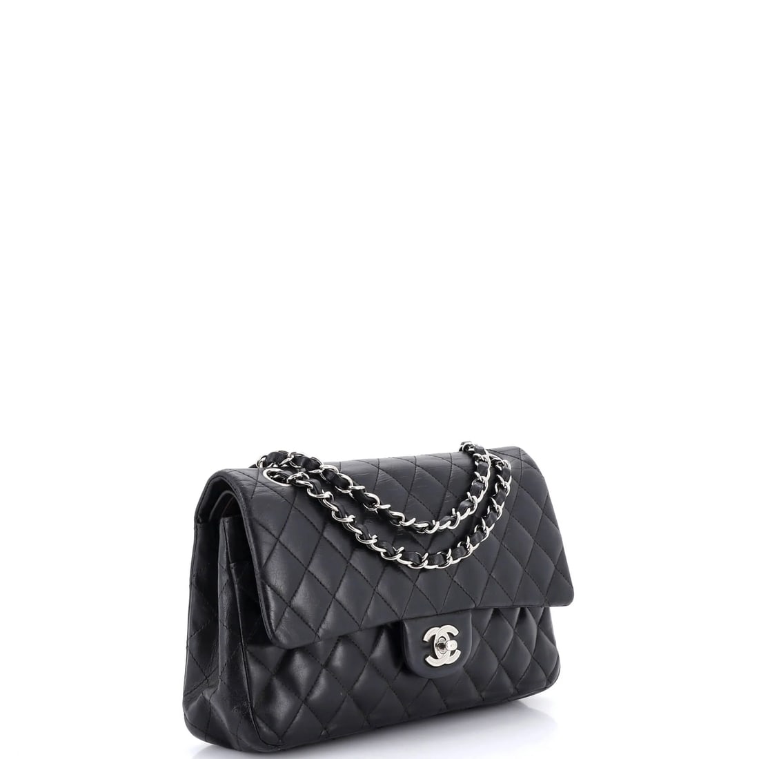 Chanel Vintage Classic Double Flap Bag Quilted Lambskin Medium: The Chanel Vintage Double Flap Bag opens with the balanced proportion and finish that define the model, rendered in quilted lambskin leather. The Classic format strikes a versatile middle ground in th