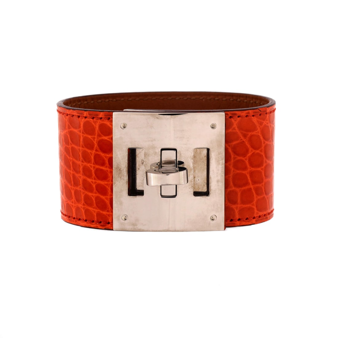 Hermes Kelly Dog Bracelet Alligator: Alligator defines this Hermes Kelly Dog Bracelet. Borrows the Kelly's turn-lock language, scaled down with the same clean, saddlery-rooted lines. Secure on the wrist and easy to layer or wear solo. Co