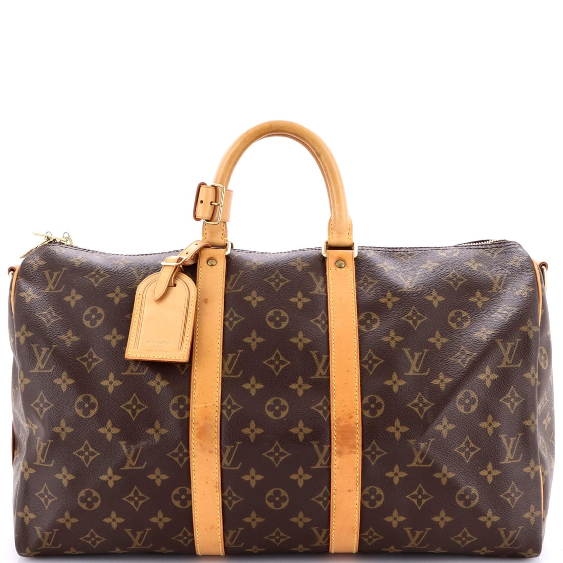 Louis Vuitton Keepall Bandouliere Bag Monogram Canvas: Here, the Louis Vuitton Keepall Bandouliere Bag. Strap on, it is an airport bag; strap off, a clean overnight duffel. 18"W x 11"H x 8"D, 4" handle drop and 20" strap drop on the body. A practical carr