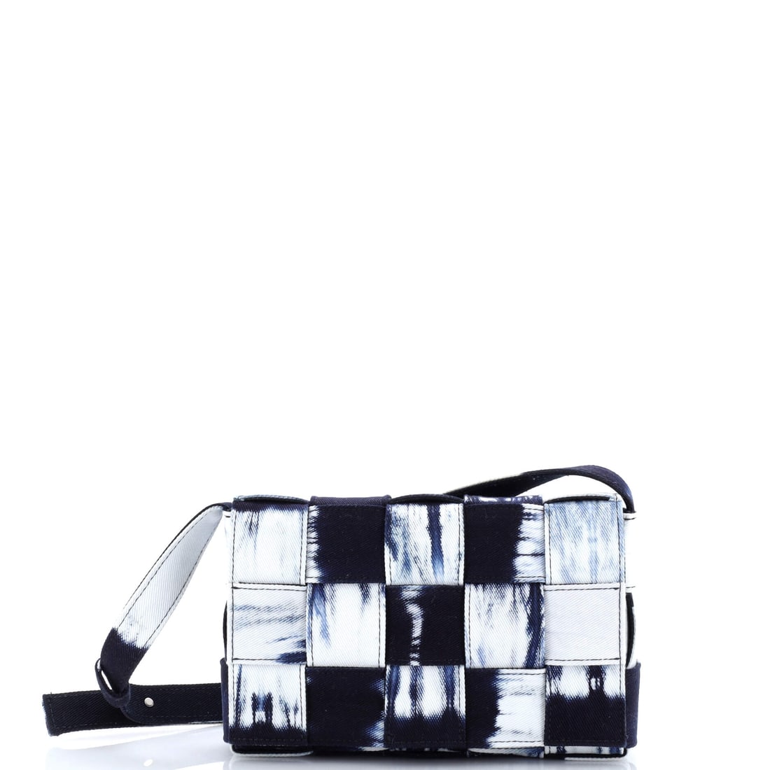 Bottega Veneta Cassette Crossbody Bag Maxi Intrecciato Tie Dye Denim: A Bottega Veneta Cassette Crossbody Bag in maxi Intrecciato Tie Dye Denim. Soft to the touch and sharply squared, it balances comfort against a clean line. Scale sits at 9"W x 5.5"H x 2"D, 20" strap d