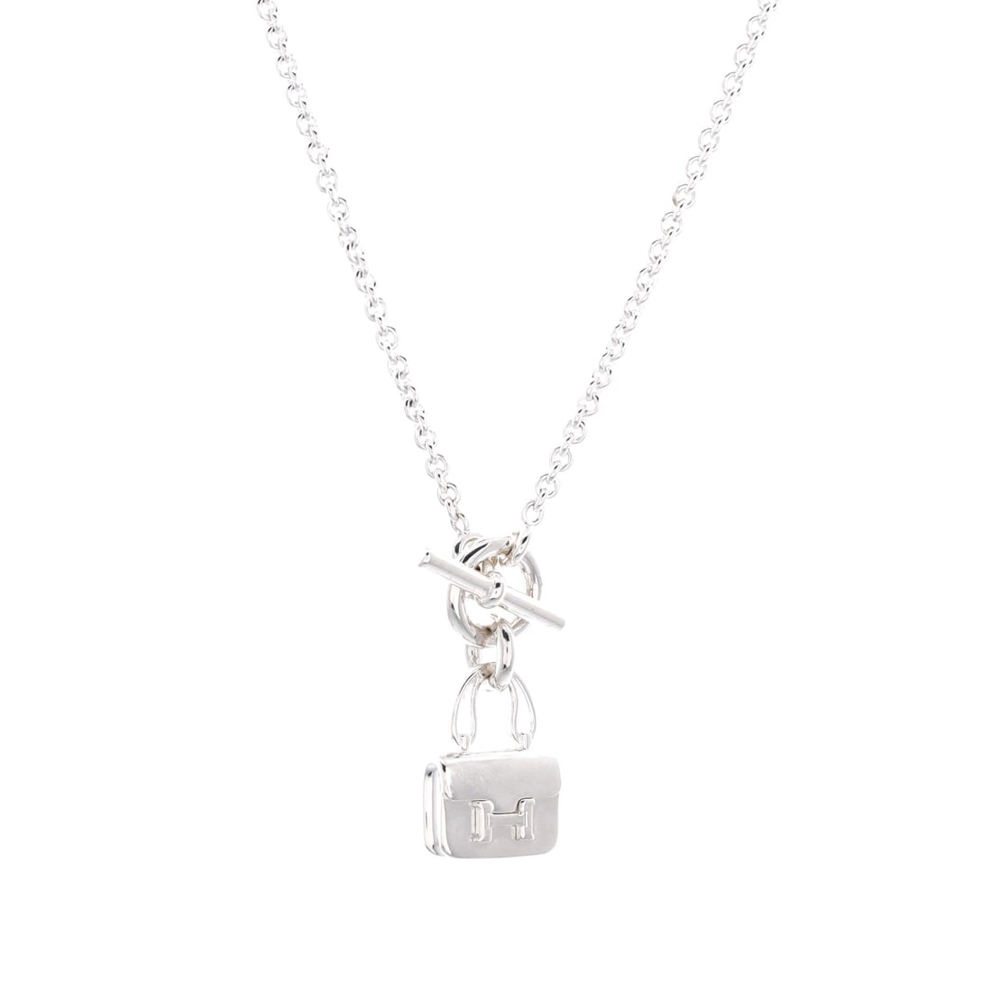 Hermes Amulettes Constance Pendant NM Necklace Sterling Silver: Sterling silver on the Hermes Amulettes Constance Pendant NM Necklace. A pendant necklace with a balanced, everyday drop. It measures 16" in length. Offered in Grade B - Excellent condition. Maison de