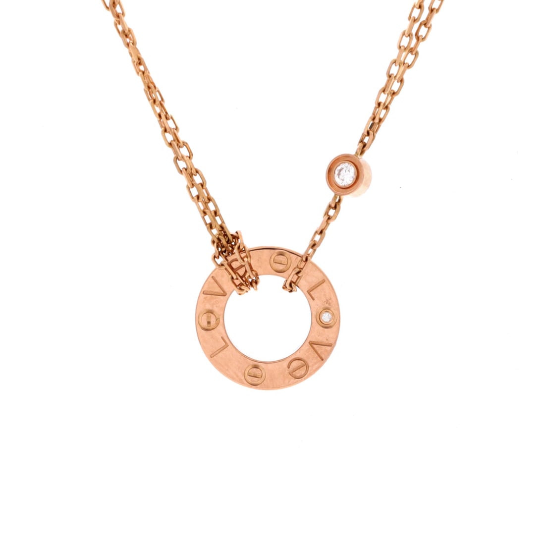 Cartier 2 Diamonds Love Pendant Necklace 18K Rose Gold and Diamonds: This example of the Love pendant necklace comes in 18K rose gold set with diamonds. That is enough to catch light without moving the piece into full pave territory. The chain adjusts between 15 and 16