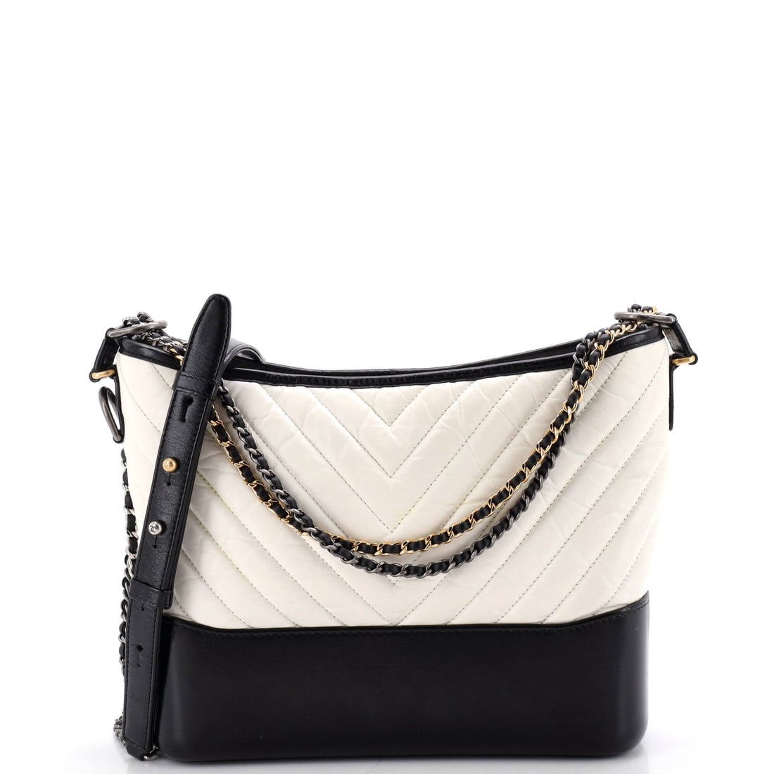 Chanel Gabrielle Hobo Chevron Aged Calfskin: Between a structured flap and a soft tote sits the Gabrielle, and the hobo cut is the loosest version of the family. Chevron quilting on aged calfskin runs the panels in a V where a diamond would norm