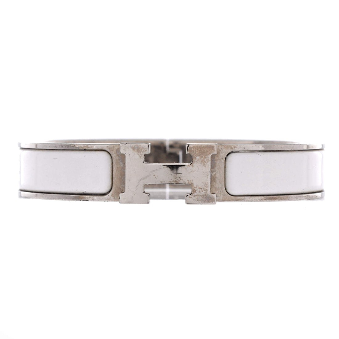 Hermes Clic H Bracelet Enamel: Enamel is the reason this one holds its look, a glassy coat over plated metal that resists the dulling that plagues polished silver. Narrow at 12 mm, it reads as a daily bracelet more than an occasion