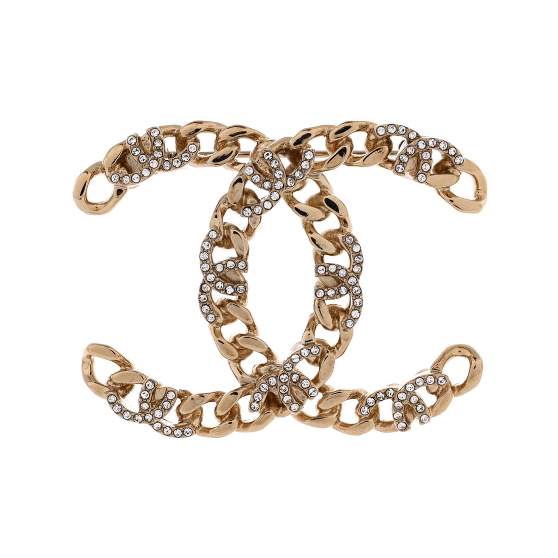 Chanel CC Chain Brooch Metal with Crystals: CC Chain brooch pairs the interlocking logo with a chain element and crystal detailing on metal, the combination that sets it apart from Chanel's plain logo pins. At 50 mm wide and 39 mm long it holds