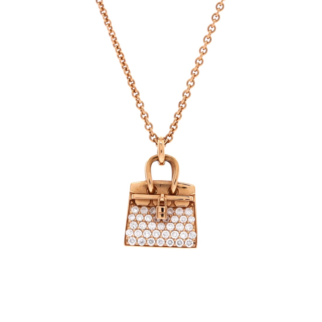 Hermes Birkin Amulette NM Pendant Necklace 18K Rose Gold and Diamonds: Hermes reduces the Birkin to a 15.8 x 12.45 mm charm in 18K rose gold, diamond-set, on a chain adjustable between 15 and 15.75 in. That length sits at the base of the throat, high enough to wear with 
