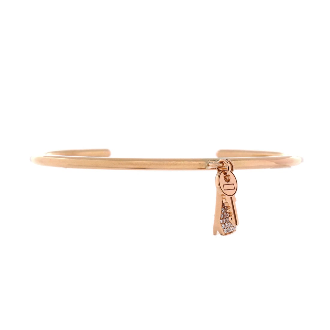 Hermes Kelly Clochette Cuff Bracelet 18K Rose Gold with Diamonds: Diamonds trace the clochette on this rose gold cuff, the charm doing the decorative work while the rigid band holds the shape. Cuffs suit anyone who dislikes fiddling with clasps, and the profile here