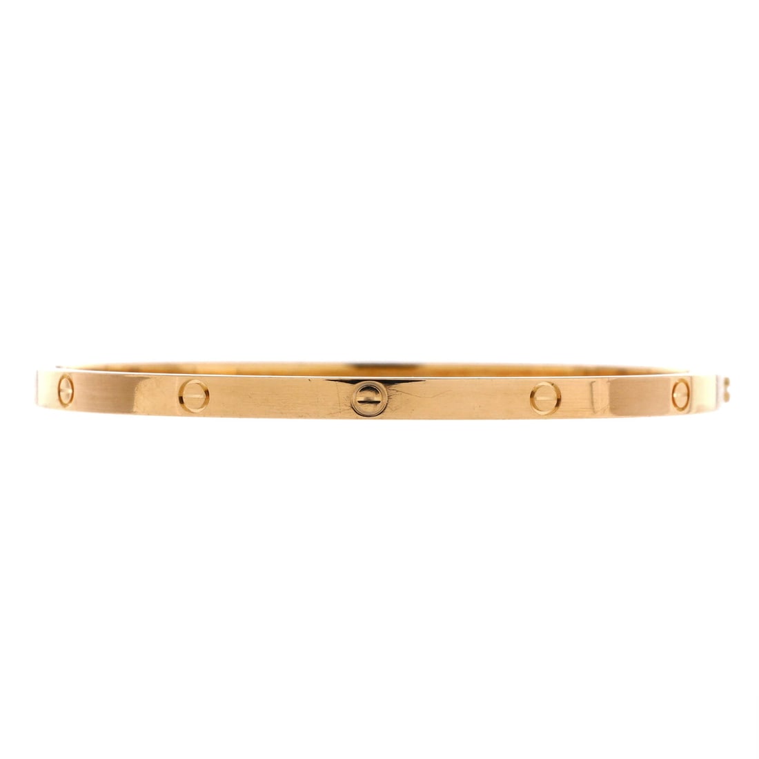 Cartier Love Bracelet 18K Yellow Gold: Narrow yellow gold, 3.6 mm across, and the familiar pair of screws holding the two halves in line. This is the small model, sized here with room to move, so it travels along the wrist through the day.