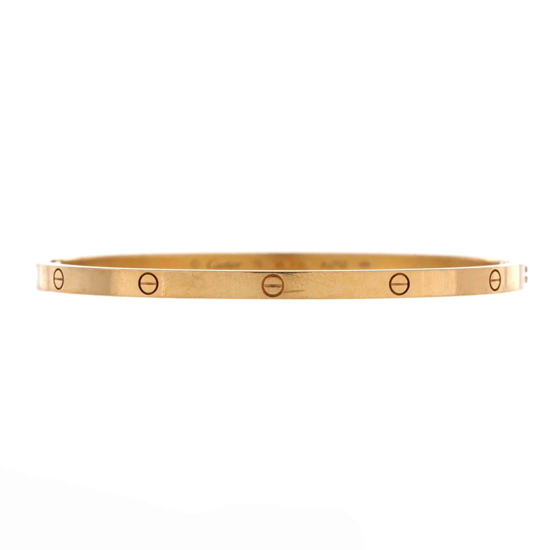 Cartier Love Bracelet 18K Yellow Gold: Yellow gold Love bangle, no stones, closing on the screwdriver mechanism that fixes it to the wrist. The screw heads are the entire design language, and in yellow gold they read warmest. Grade C - Ver