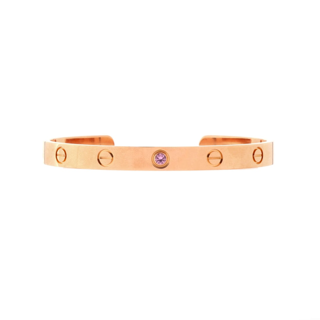 Cartier Love Cuff Bracelet 18K Rose Gold with Pink Sapphire: A pink sapphire sits in place of one screw head here, a small note of colour against rose gold that the all-gold cuffs do not have. Grade A - Pristine, with no wear worth noting. The 6.1 mm band is th