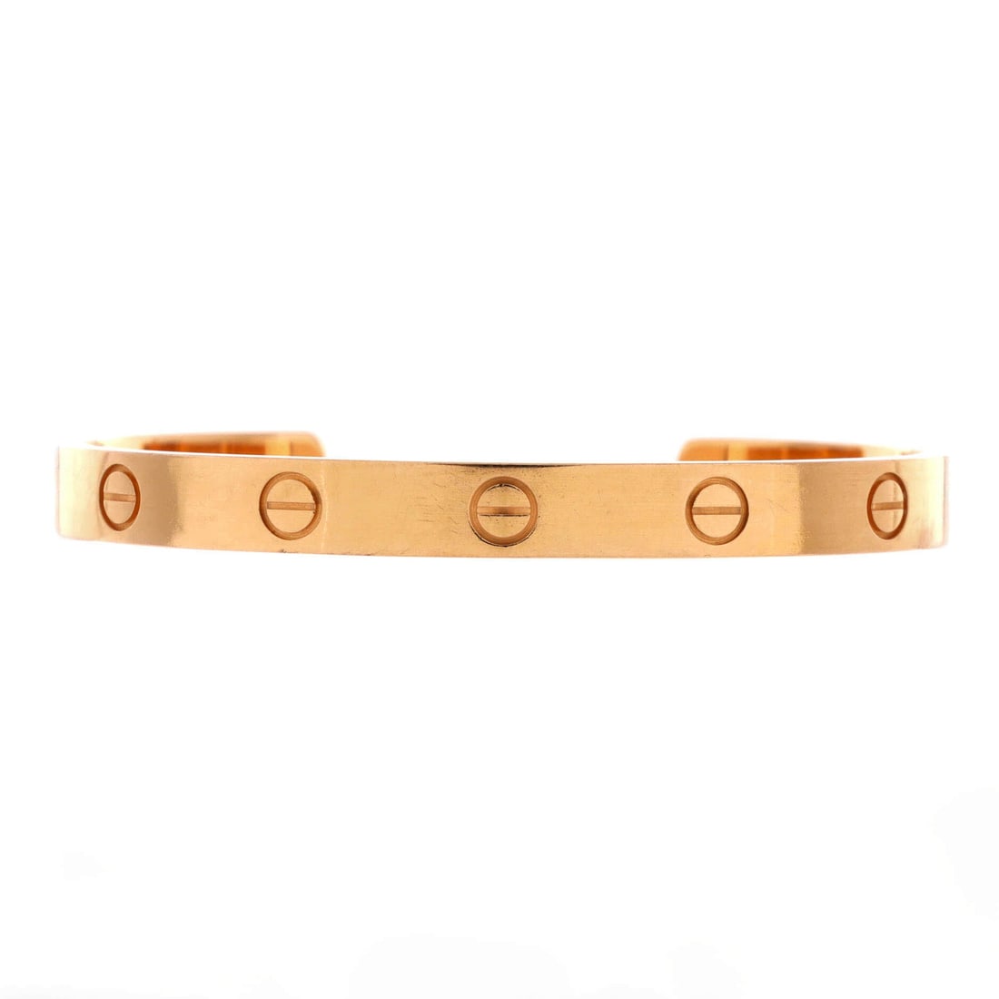 Cartier Love Cuff Bracelet 18K Rose Gold: Rose gold, 6.1 mm wide, and open at the back: the cuff for people who prefer to take their jewelry off. The gap sits beneath the wrist, so the screw motif runs unbroken across everything you actually 