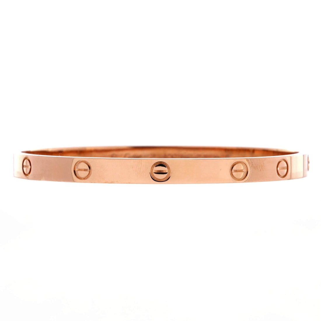 Cartier Love Bracelet 18K Rose Gold: Nearly 6 mm across, this rose gold Love bangle is the classic width rather than the small model, and the extra metal changes how it sits. Screw heads run the full sweep of the band in even sequence. G