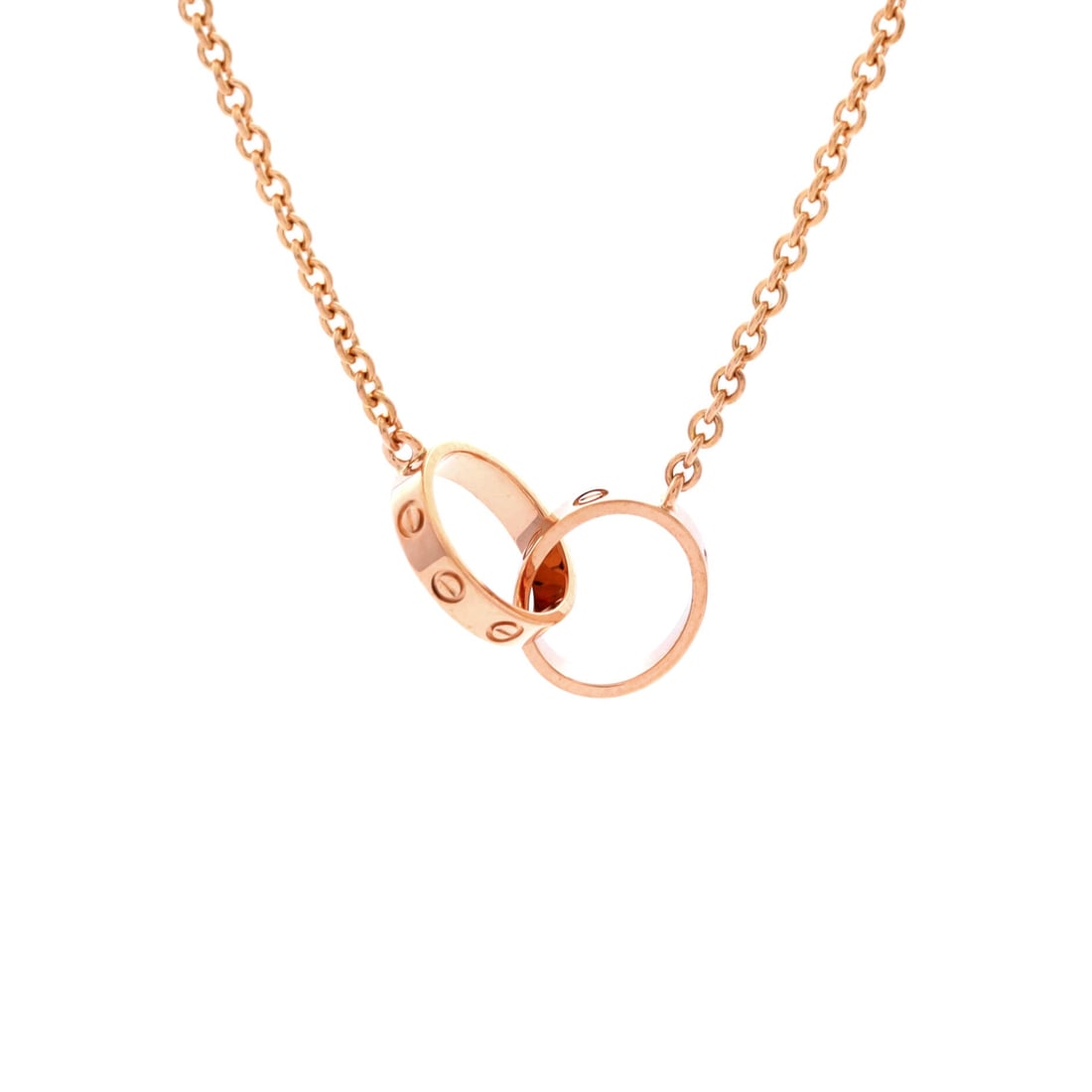 Cartier Love Interlocking Necklace 18K Rose Gold: The 20 mm span of the interlocking motif is the deciding detail on this rose gold Love necklace: wide enough to register across a room, at 2.6 mm thin enough to lie flat under a shirt collar. Cartier 