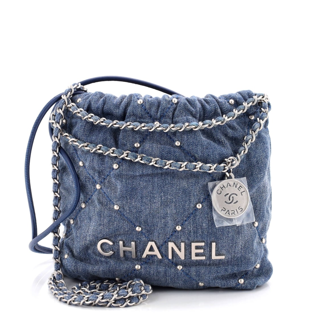 Chanel 22 Chain Hobo Quilted Studded Denim: Studs across the denim give this 22 a harder edge than the plain versions, catching light along the quilt seams. The hobo body still slumps and still gathers shut through the eyelet-and-chain top. Its