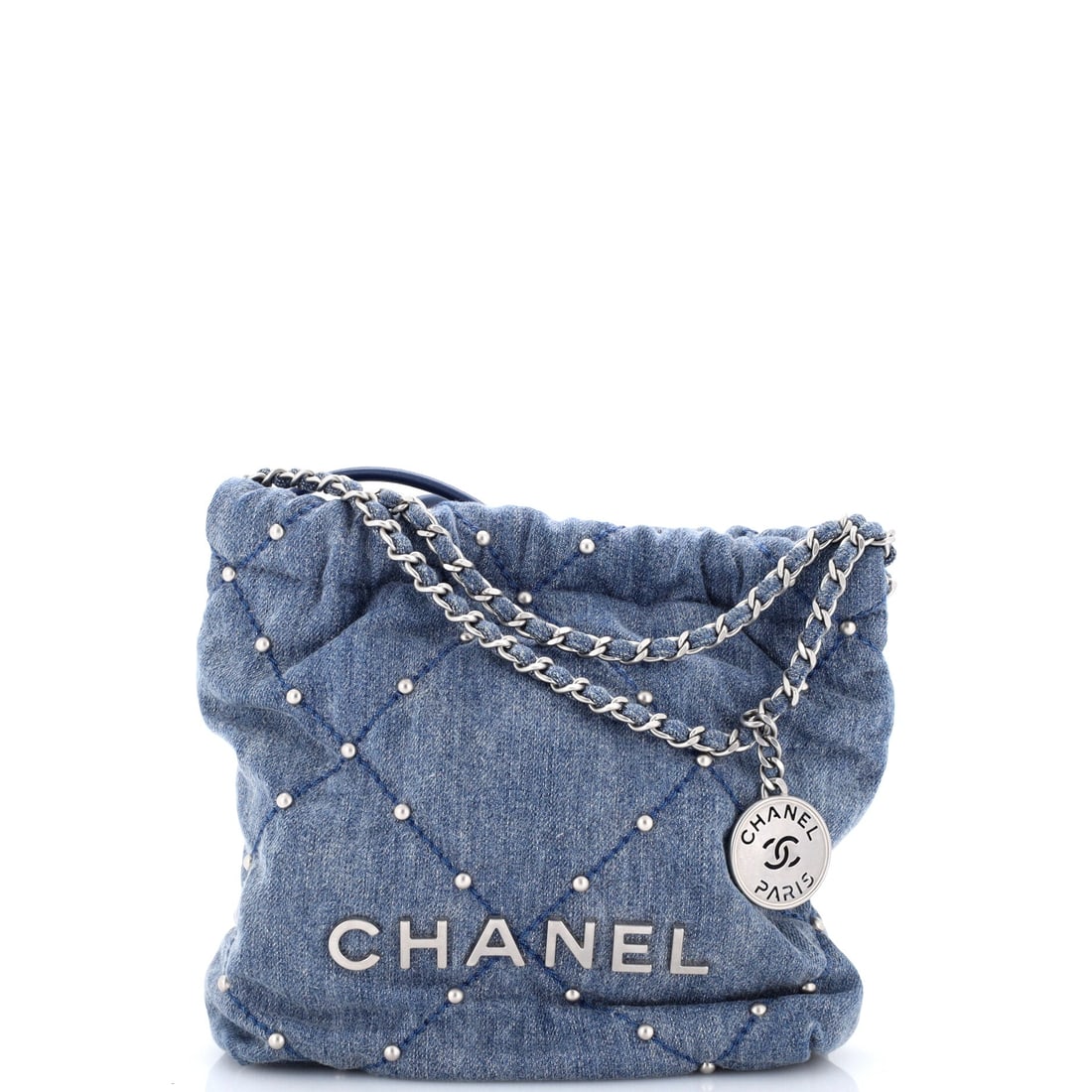 Chanel 22 Chain Hobo Quilted Studded Denim: Hardware detailing is what separates this denim 22 from its plainer siblings, with studs punctuating the quilted panels across the body. Chain-and-leather straps and the drawstring top remain as the l