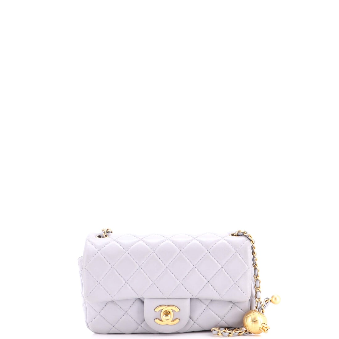Chanel Pearl Crush Flap Bag Quilted Lambskin: Worn on the 22 inch strap, this Crush flap lands at the hip and stays there, and the flat 2.5 inch depth is what makes that comfortable. Lambskin takes the quilting softly, giving the 7.5 inch front a