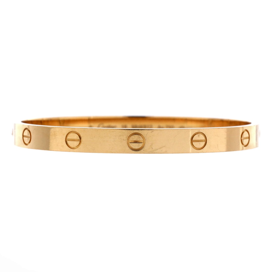 Cartier Love Bracelet 18K Yellow Gold: Full 6 mm width in yellow gold gives this Love bangle noticeably more mass than the small model, and it sits flatter and steadier for it. The screw heads scale up in proportion, so the motif carries a