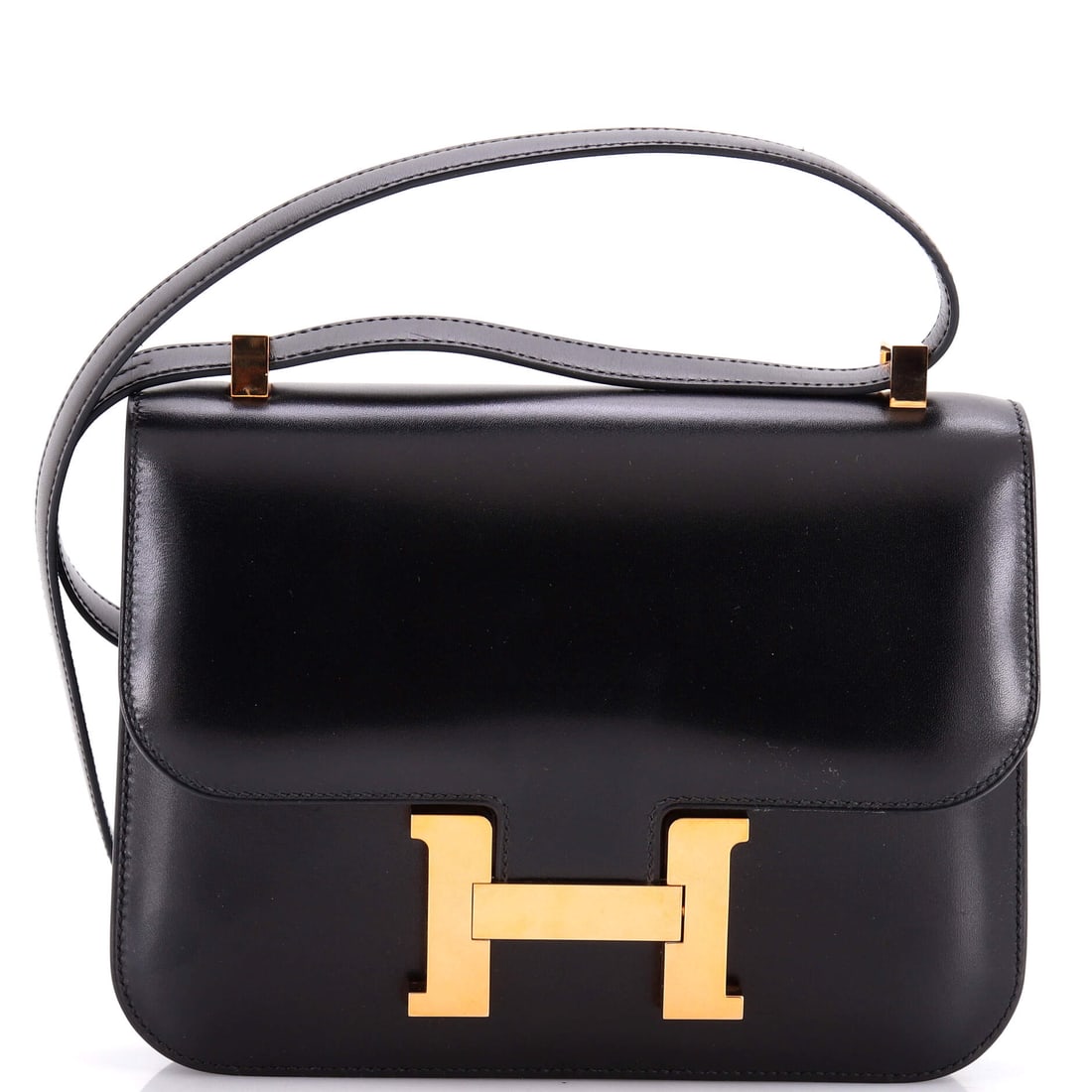 Hermes Constance NM Bag Box Calf: Box calf on a Constance gives the flap a mirror-smooth face, which frames the H clasp more sharply than any grained leather can. At 9 in wide, 7 in high and 3 in deep this is the larger Constance body