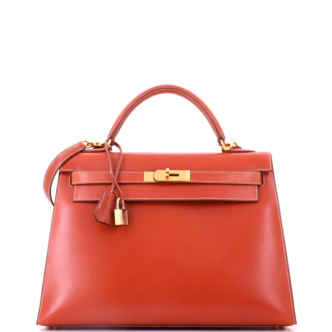 Hermes Kelly Handbag Orange Box Calf with Gold Hardware: Orange box calf is an uncommon pairing - the house color on the glossiest leather Hermes works in, which makes the surface look almost enamelled. Gold hardware at 13 in wide, 9 in high and 4 in deep. 