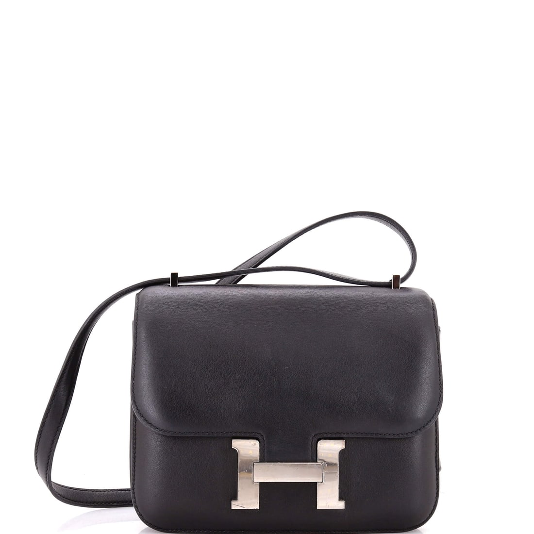 Hermes Constance Bag Swift: Swift gives a small Constance a softer, more saturated face than Epsom, which changes how the H reads against it. Seven inches wide, 6 in high, 2 in deep, with a 20 in strap. Grade C - Very Good. Mais
