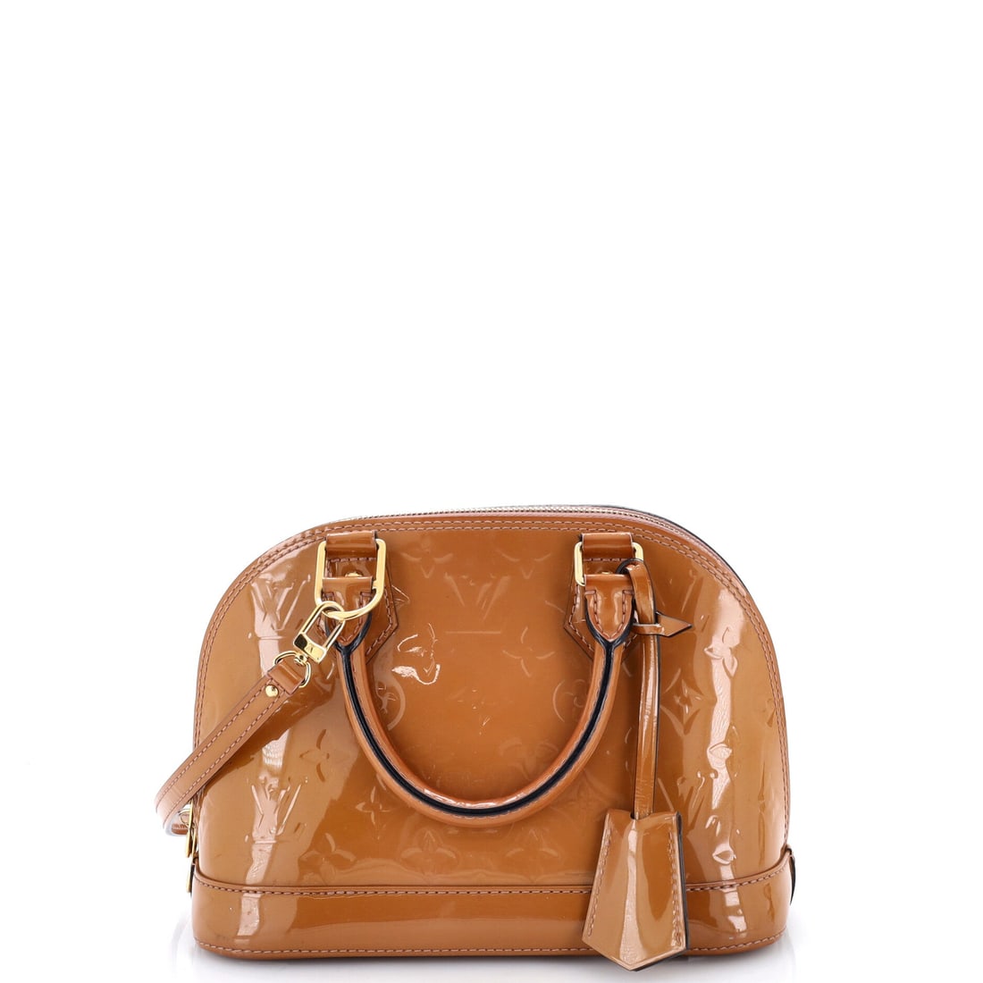 Louis Vuitton Alma Handbag Monogram Vernis: The domed silhouette reads differently at BB scale, tighter and more object than bag, the top zip pulled into a short arc that the larger sizes stretch out over a longer sweep. Compactness is what mak