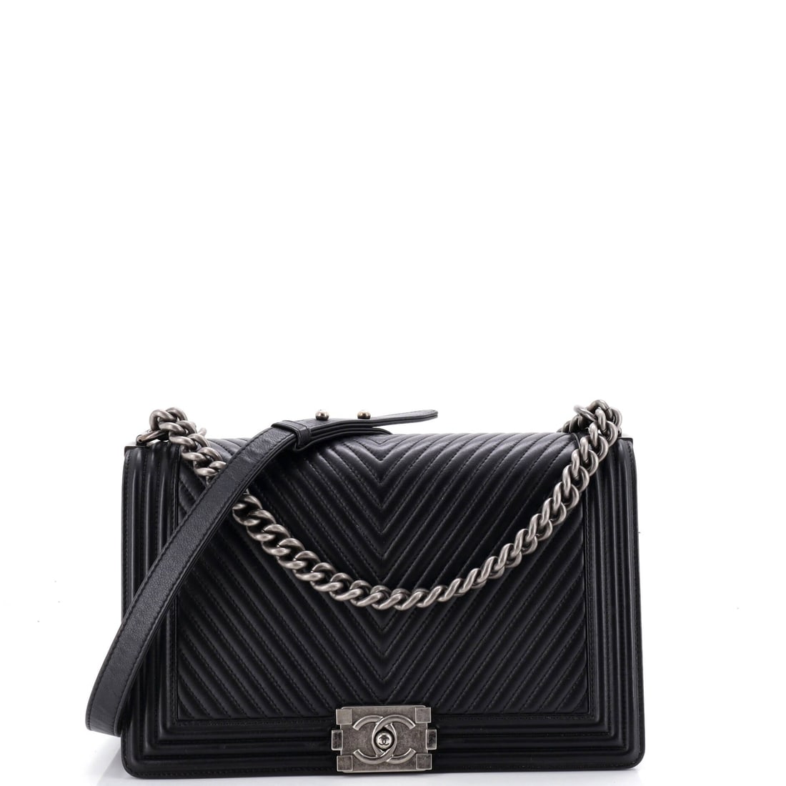 Chanel Boy Flap Bag Chevron Calfskin: New Medium is the differentiator here, and the difference is immediately physical: 11 by 7 by 3 inches puts real width across the front, and the chevron pattern scales up with it. Buyers who find the 