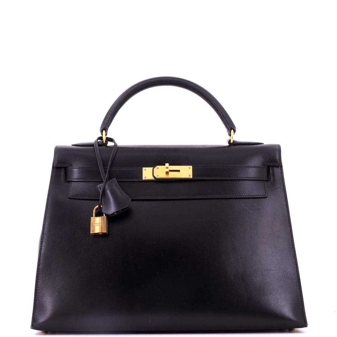 Hermes Kelly Handbag Black Box Calf with Gold Hardware: Black Box Calf with gold hardware on a Kelly at 12.5 in wide, 9 in high and 4 in deep. This is the pairing Hermes has been making longest, and it reads like a piece of luggage from the house's saddler