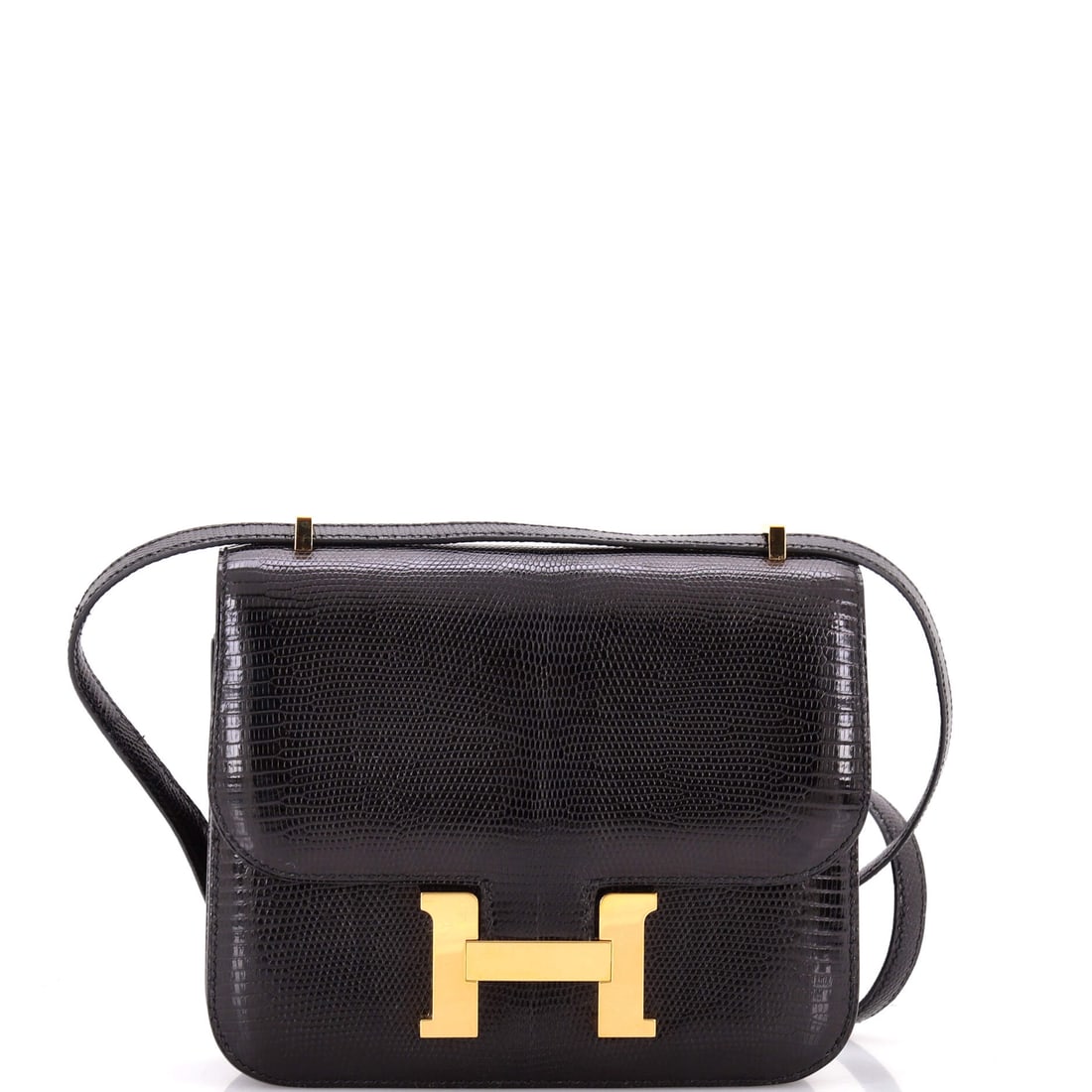 Hermes Constance NM Bag Lizard: Lizard on a small Constance is exotic-skin territory, with the fine scale pattern working against a front panel that is mostly clasp. Measures 7.5 in wide, 6 in high and 2 in deep. The condition is Gr