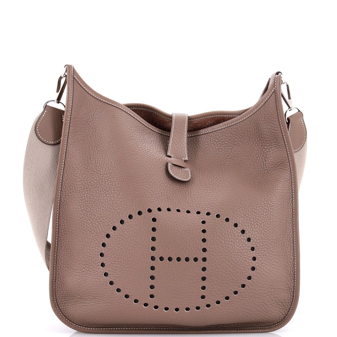 Hermes Evelyne Bag Gen II Clemence GM: Metal appears exactly twice on a Gen II Evelyne: at the buckle where the strap adjusts and at the ring it feeds through. Everything else is leather and perforation, including the H cut straight throug