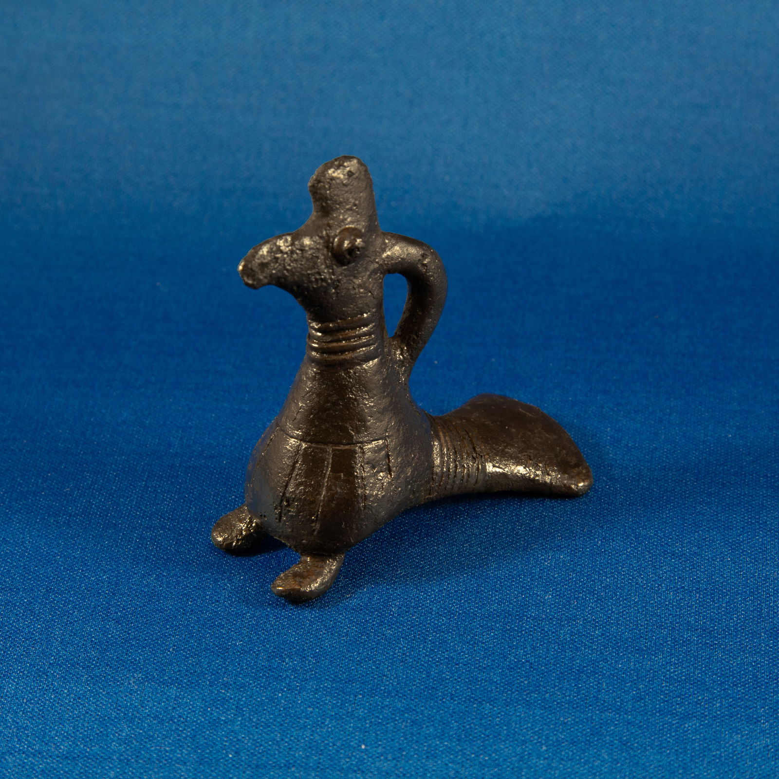 FITTING: HAWK LURISTAN (1000-500 BC): A delightful bronze pendant figurine depicting a stylized bird - likely a hawk - cast using the lost-wax technique. A loop projects from the neck, likely serving as a suspension point as a pendant. In