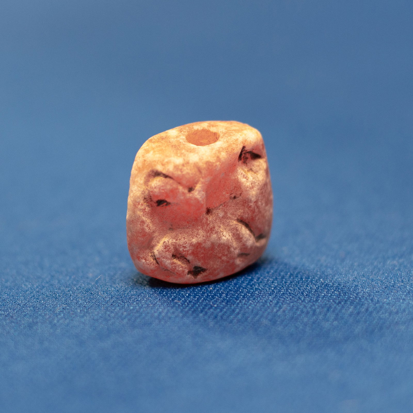 PENDANT: HORSE SASANIAN (224-651 CE): This small Sasanian seal is made of red agate and has a vertical hole, indicating that it was probably used as a pendant or personal seal. Although its surface has worn away over time, the main lines