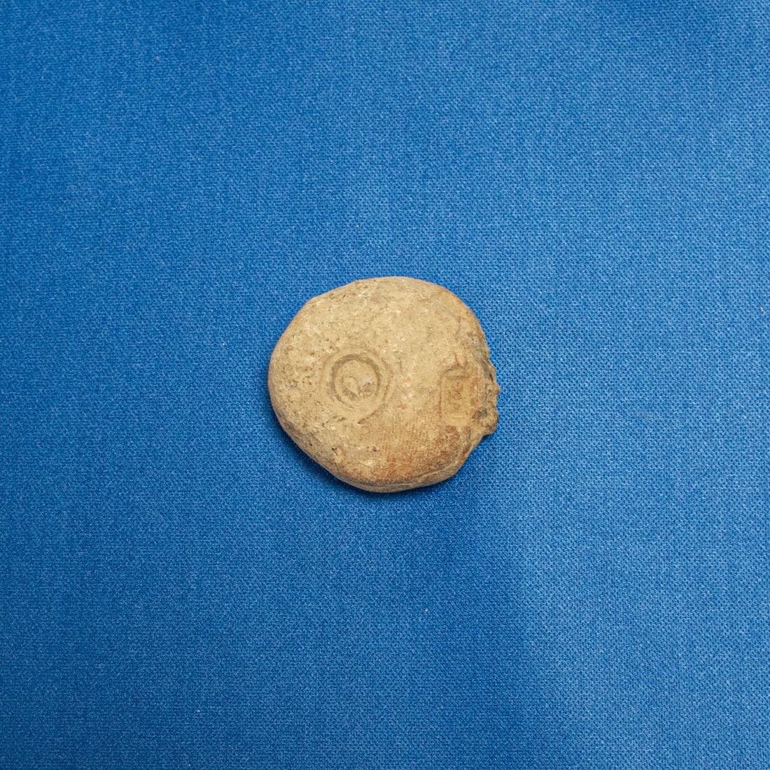 BULLA: SASANIAN BULLA FEATURING TWO SEAL IMPRESSIONS: Sasanian clay administrative bulla bearing two distinct seal impressions, including a crescent (half-moon) seal commonly associated with Sasanian administrative authority or Zoroastrian cosmology, and