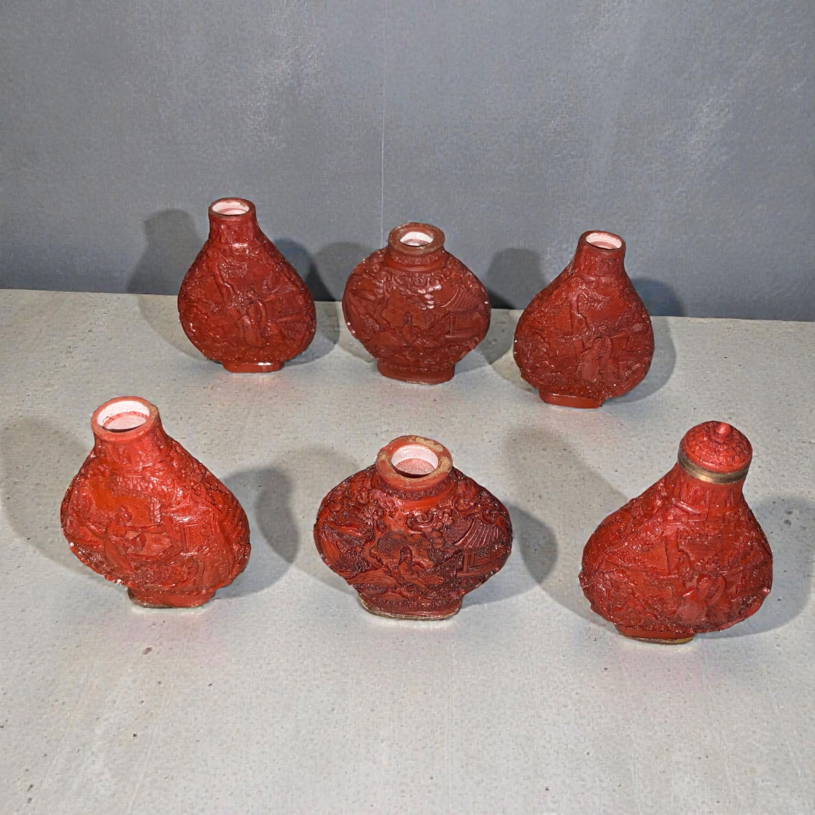 6 Antique Chinese Cinnabar Lacquer Snuff Bottles: 6 Antique Chinese Cinnabar Lacquer Snuff Bottles. Used to hold powdered tobacco and popular in China during the Qing Dynasty (1644–1912). Tallest is about 2 1/2”