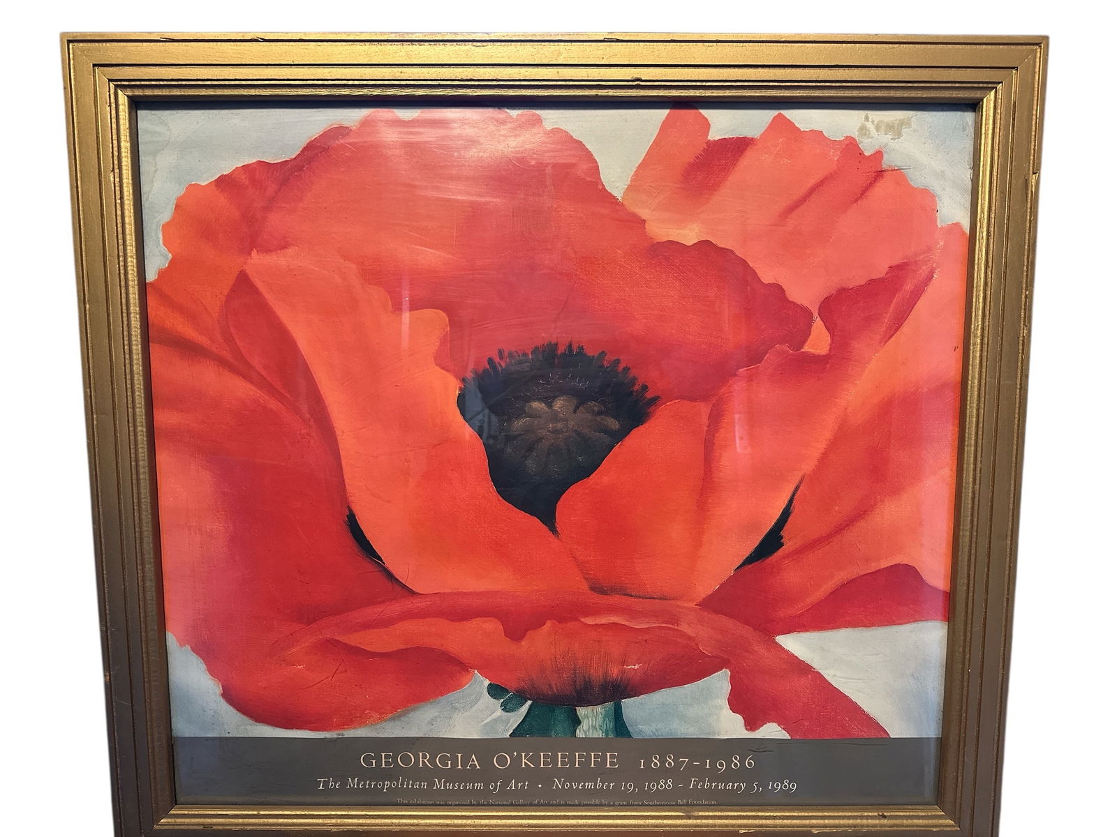 Framed Exhibition Poster for Georgia O'Keeffe's "Red Poppy": Framed Exhibition Poster for Georgia O'Keeffe's "Red Poppy". The ‘window’ is plastic and has a few light scratches which are generally unnoticeable except when very close and at the right angle. T