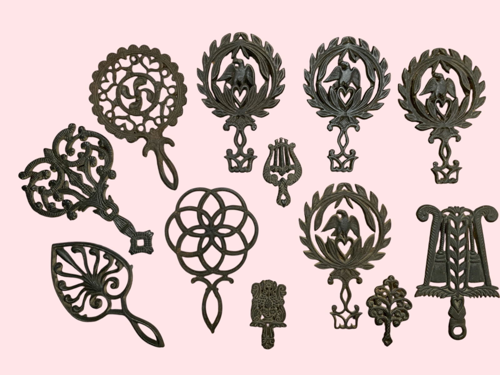 Tray lot Vintage Cast Iron Footed Trivets 12pcs: Vintage Cast Iron Trivets 12pcs. No chips, cracks, breaks, or repairs. Largest is 91/2" long.....***PLEASE READ***Shipping for this lot is available ONLY THROUGH LIVESHIPPING. There are NO full-servic