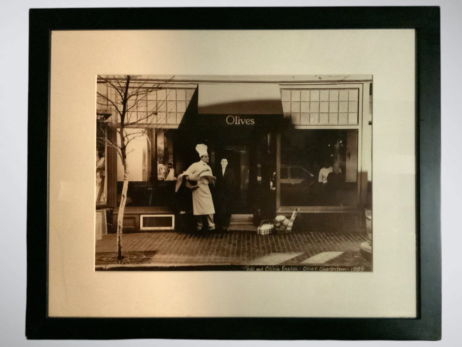 'Olives Charleston 1989' Framed Photo: 'Olives Charleston 1989' Framed Photo. 23 3/4" x 29 1/2". >>>>>>>>>>>>>>READ—-READ—-READ—-Shipping for this lot is available ONLY THROUGH LIVEAUCTIONEERS/LIVESHIPPING. We advise all bidders to o