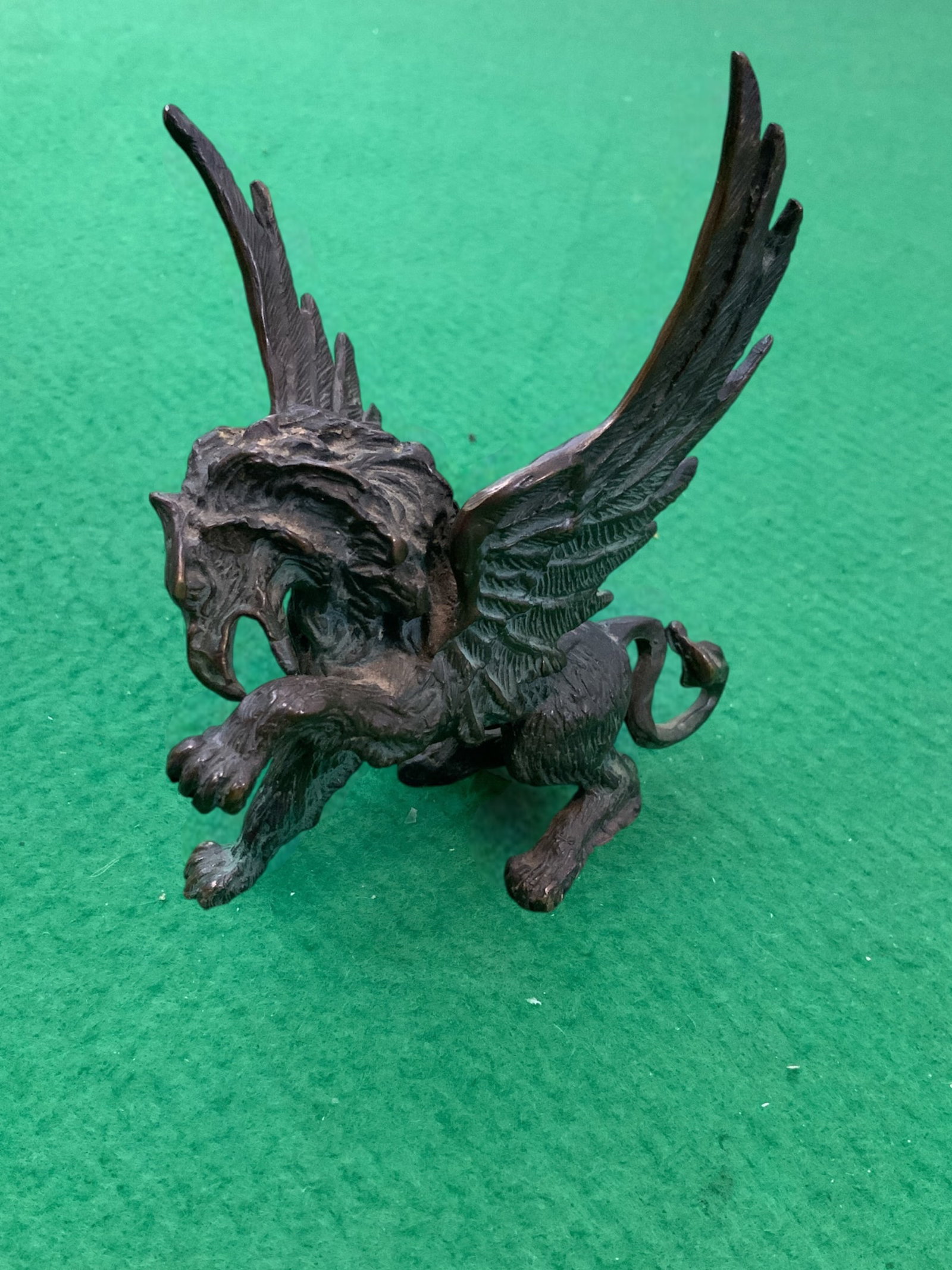 Bronze(?) Griffin Figurine / Paperweight: Bronze(?) Griffin Figurine / Paperweight. Crafted with meticulous detail including pads on the underside of the paws. Feels heavy for its size, is not magnetic and looks like bronze. No guarantee-you 