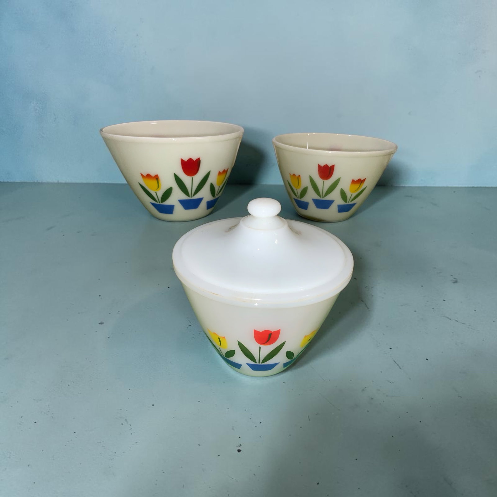 Vtg Tulip Mixing Bowls and Lidded Grease Jar Fire-King Oven Ware: Vtg Tulip Mixing Bowls and Lidded Grease Jar Fire-King Oven Ware. Some utensil marks but not a heavy burden. Also some color loss/fading but look at the photos. They are beautiful. 8 1/2" and 9 1/2" b