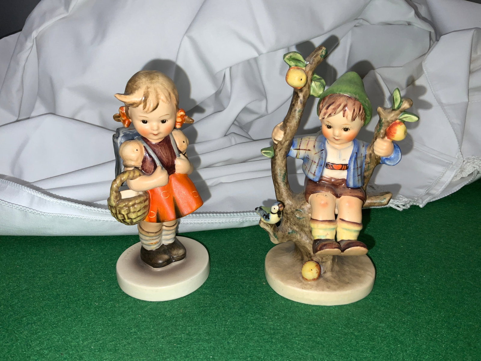 (2) Hummel Figurines 'Apple Tree Boy' & 'School Girl': (2) Hummel Figurines 'Apple Tree Boy' & 'School Girl'. 5 3/4" tallest. .>>>>>>>>>>>>>>READ—-READ—-READ—-Shipping for this lot is available ONLY THROUGH LIVEAUCTIONEERS/LIVESHIPPING. We advise al