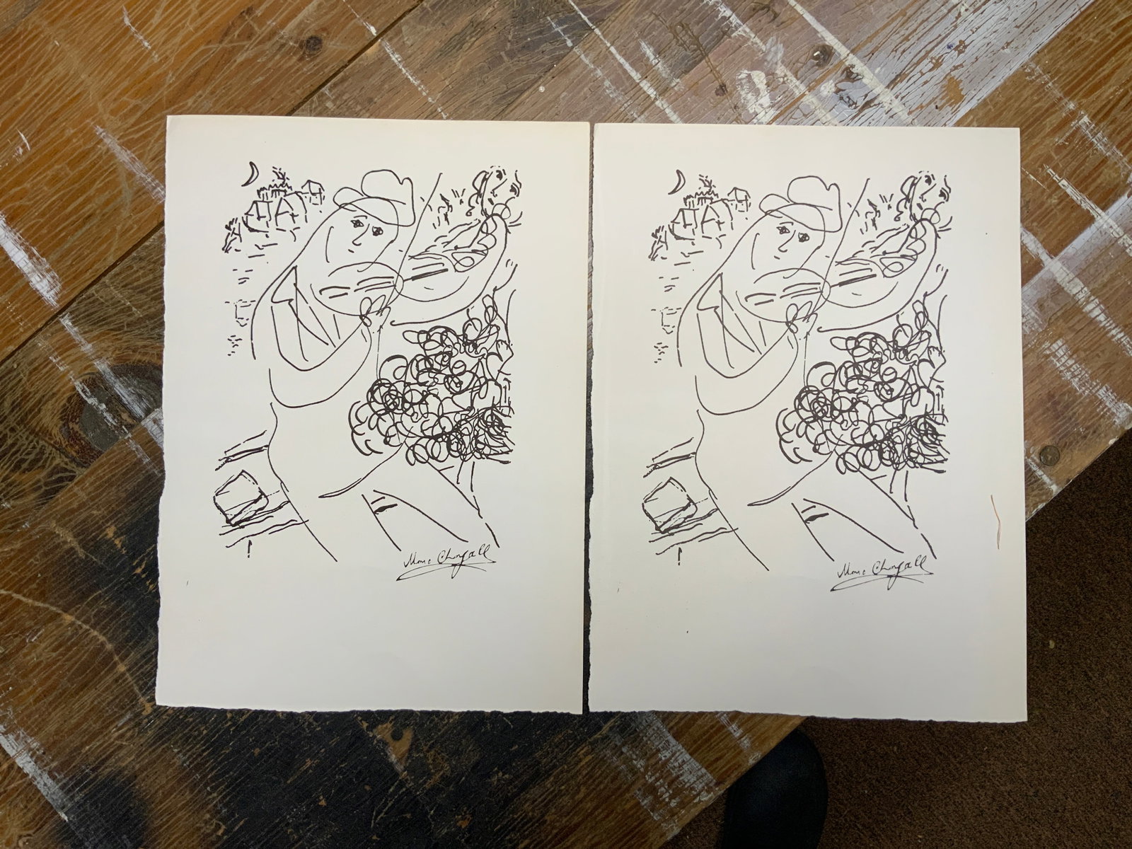 (2) Marc Chagall Prints Violinist in Front of a Village Scene: (2) Marc Chagall Prints Violinist in Front of a Village Scene. Appear to be removed from a portfolio. Final picture shows the reverse side. 10" x 14". .>>>>>>>>>>>>>>READ—-READ—-READ—-Shipping f