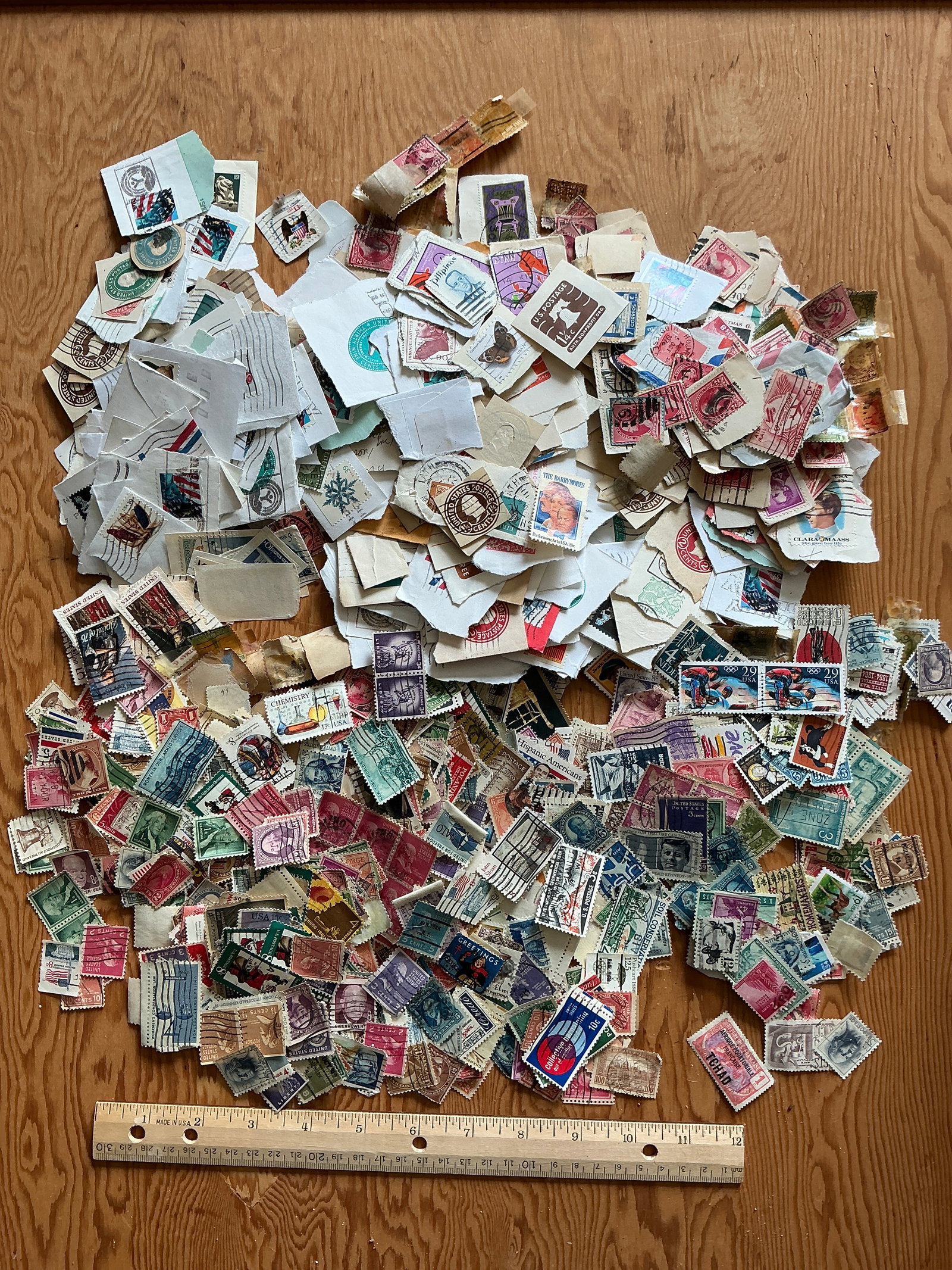 Large Cancelled Stamp Lot: Large Cancelled Stamp Lot. Loose stamps in the foreground, still attached to envelope or postcard material in the background. Random and wide range of age and subject. Have not been counted but I’d 