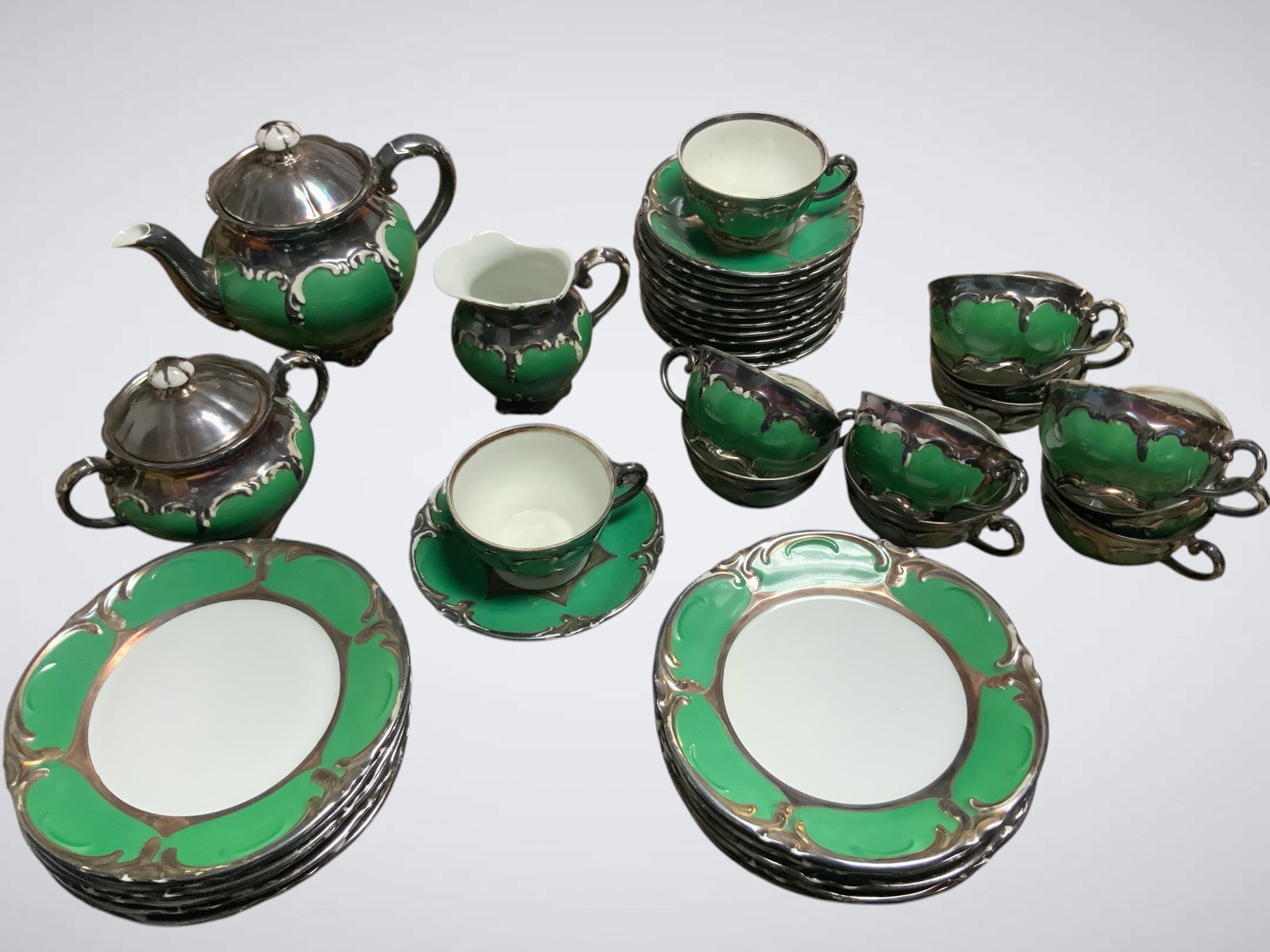 Vintage Sterling Silver Drip over Green Glaze China Tea / Coffee Dessert Set 38pc: Vintage Sterling Silver Drip over Green Glaze China Tea / Coffee Dessert Set 38pc. References attribute this set to Rudolf Wächter (RW) Bavaria. I don't see that name on any piece. Plates are 7 1/2" 
