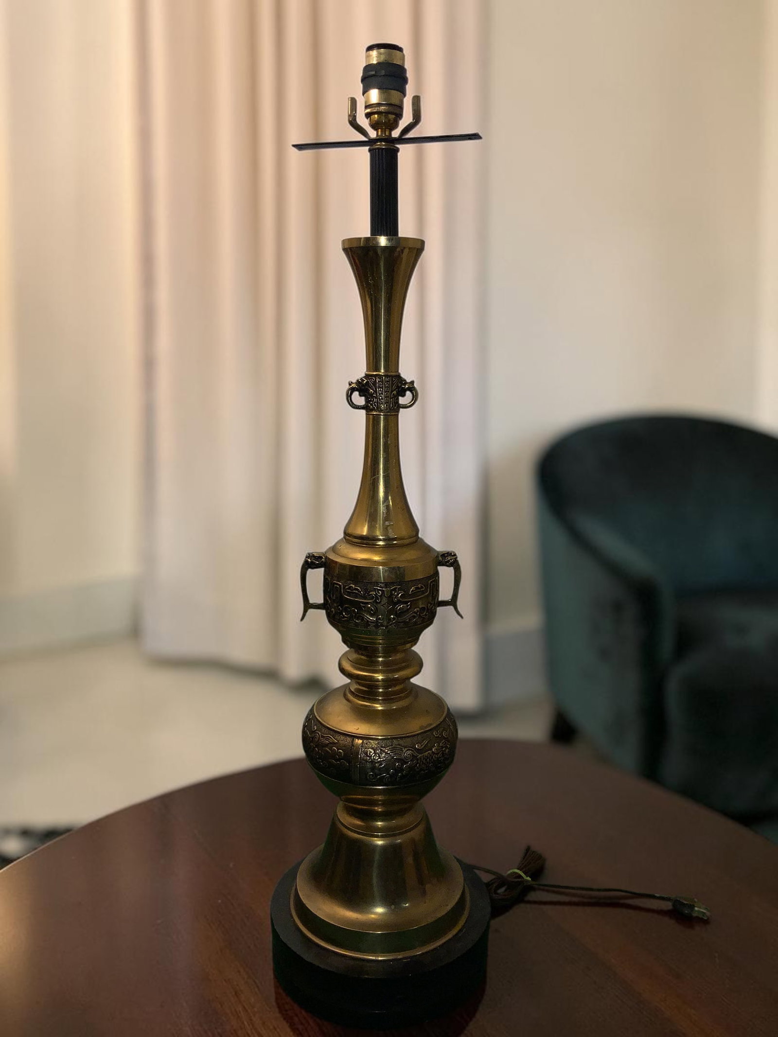 Tall Hollywood Regency Asian-inspired Brass TABLE LAMP: GET A SHIPPING QUOTE BEFORE YOU BID. .Tall Hollywood Regency Asian-inspired Brass TABLE LAMP. Closed loop handles and embossed motifs. Three-way switch(black collar on the socket slides down to actuat